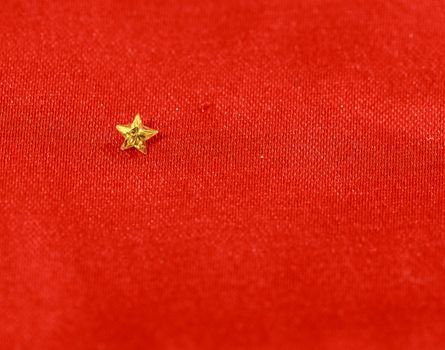 Yellow canary diamond in the shape of a star on a red background