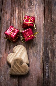 hand-carved symbolic wooden heart on a background of yellow roses