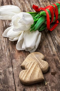 bouquet of tulips bright color and symbolic wooden heart