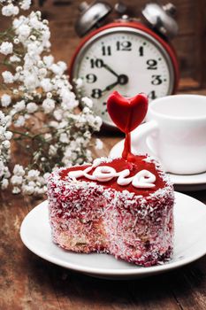 cake in the shape of heart with the inscription love and bunch of berries of viburnum