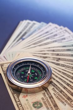Business concept. Closeup of compass on USA dollar bank notes