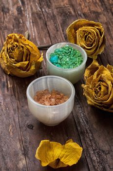 sea aromatic salt for Spa treatments on the background of yellow rose buds