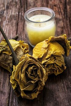 hand-carved symbolic  candle wax on background of yellow roses