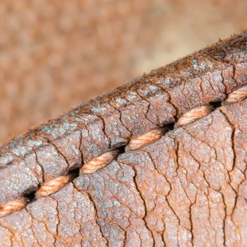 Close-up of old stiches in leather, vintage suitcase