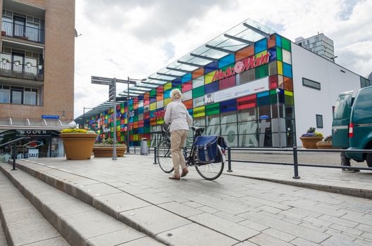 Almere, Netherlands - May 5, 2015: People walking in Modern city center of Almere, Flevoland, the newest city in the Netherlands, where construction began in 1975.