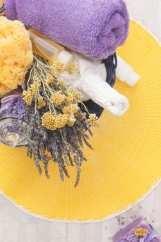 Beauty products, lavender and helichrysum in spa basket. Overhead view with retro style processing, copy space. Natural light