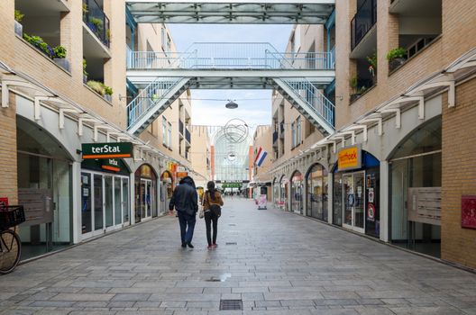 Almere, Netherlands - May 5, 2015: People shopping at the modern city center of Almere, Flevoland, the newest city in the Netherlands, where construction began in 1975.