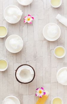 Bowls of coconut oil and fresh coconut, still life pattern background. Overhead view