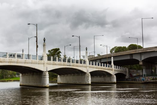 MELBOURNEAUSTRALIA - FEBRUARY 2: Hoddle Bridge which crosses the Yarra River in Melbourne. The lights of the MSG can be seen in the background.