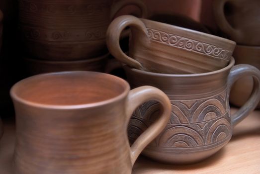 Many handmade old clay pots on the shelf.