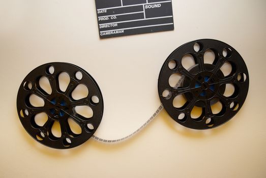 Two retro motion picture film reels with clapper board on the wall