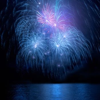 Blue fireworks on the black sky background