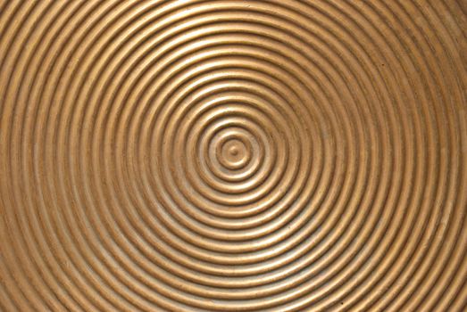 Abstract circle metal plate- golden surface with round lines.