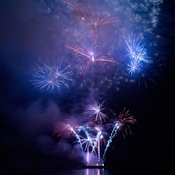 Colorful holiday fireworks on the black sky background.