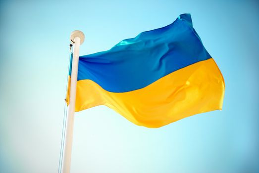 Ukrainian blue and yellow flag on the sky background