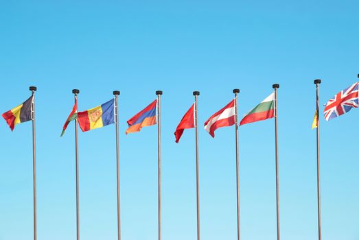 Row of european flags against blue sky background