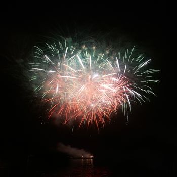 Colorful holiday fireworks on the black sky background.