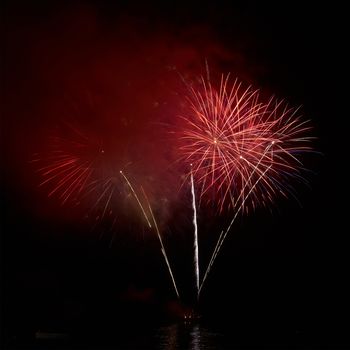 Colorful holiday fireworks on the black sky background.