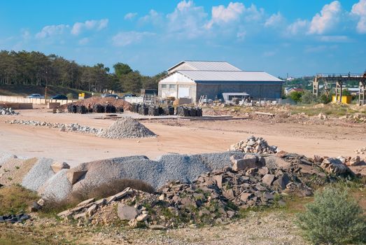 Stone and sand industry. Factory with constructions and warehouse.