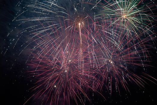 Colorful holiday fireworks on the black sky background.