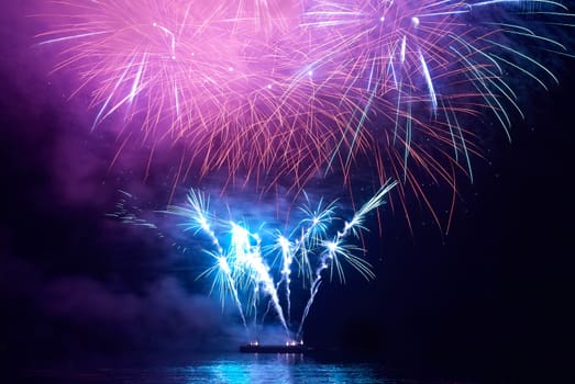 Blue colorful holiday fireworks on the black sky background.