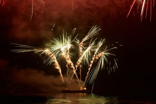 Colorful holiday fireworks on the black sky background.