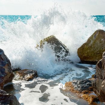 Sea, big wave and splash over the stones