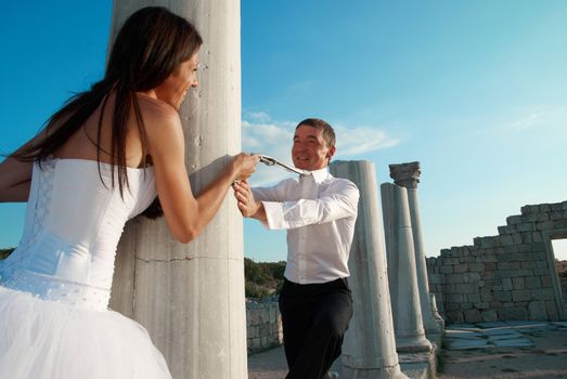 Beautiful wedding couple- bride and groom near greece column in the ancient city