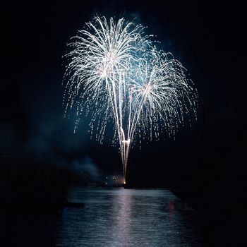 Colorful holiday fireworks on the black sky background.