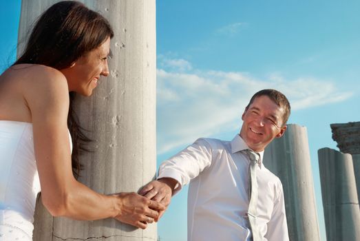 Beautiful wedding couple- bride and groom near greece column in the ancient city