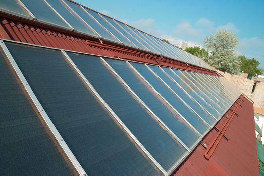 Solar water heating system on the red roof. Gelio panels.