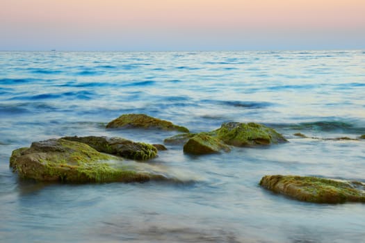 Rocks in the sea against beautiful sunset