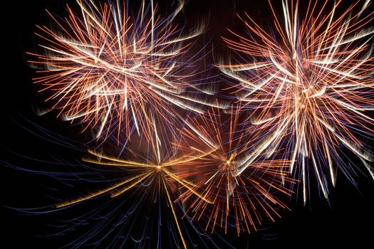 Red colorful holiday fireworks on the black sky background.