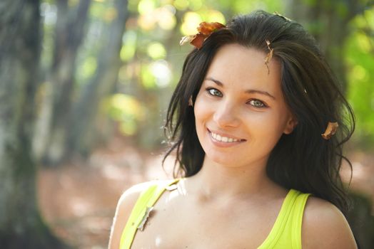 Pretty girl in the autumn forest with yellow leaves