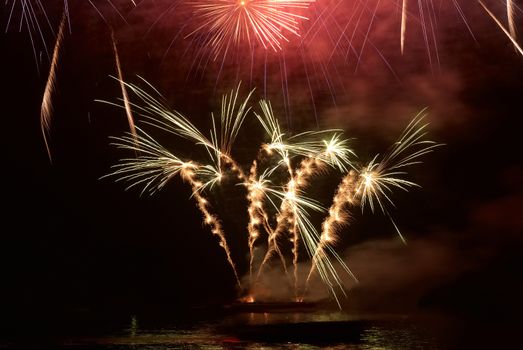 Colorful holiday fireworks on the black sky background.