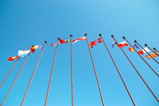 Row of european flags against blue sky background