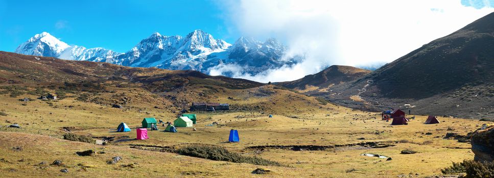 Campsite with tents on the top of high mountains, covered by snow. Kangchenjunga, India.