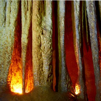 Unique cave formation- big stalactites, stalagmites and columns. Shooting deep under ground with candle light