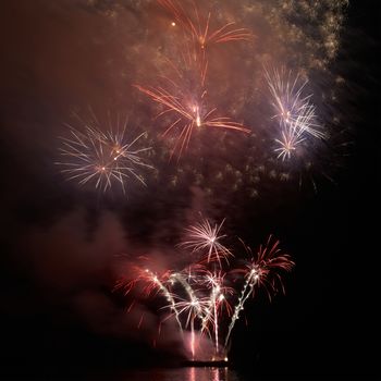 Colorful holiday fireworks on the black sky background.