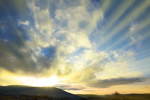 Sunset blue sky with sun and clouds