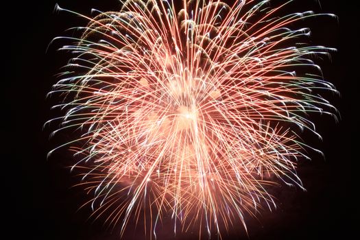 Red colorful holiday fireworks on the black sky background.