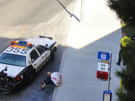 Las Vegas, USA - August 8 2010:  Man arrested by Las Vegas Police. Caucasian Man In Handcuffs Sitting On The Sidewalk, Las Vegas strip