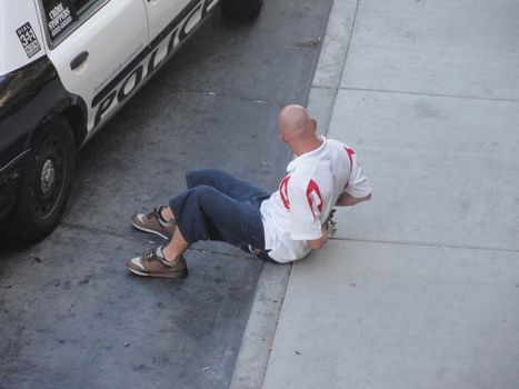 Las Vegas, USA - August 8 2010:  Man arrested by Las Vegas police. Caucasian Man In Handcuffs Sitting On The Sidewalk, Las Vegas strip
