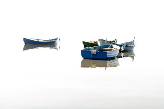 Fishing boats flying on the water. Overexposure willed.