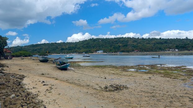 Old lonely fishing boat on the coastline of island Bali in Indonesia