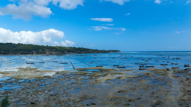 Fishing boats on the coastline of island Bali in Indonesia. Seaside Plantation shellfish.