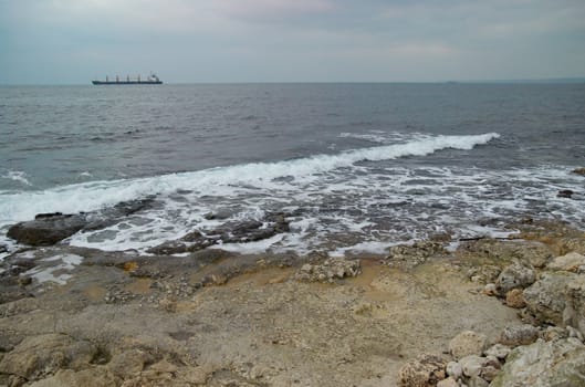 Coast with the vessel on the horizon.