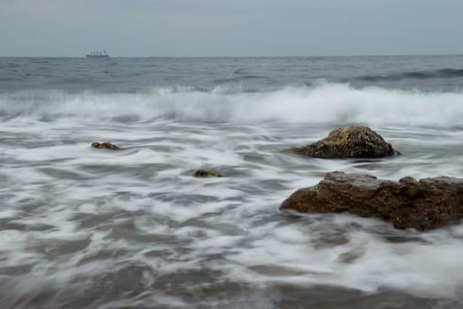 Coast with the vessel on the horizon.