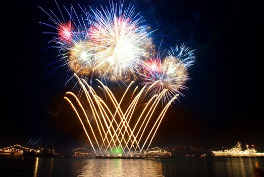 Beautiful blue holiday fireworks on the black sky background