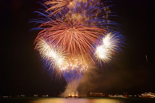 Beautiful blue holiday fireworks on the black sky background. Holiday event